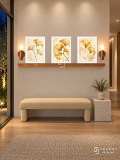 FREMAT Ginkgo Gold shelf set with three 30 x 40 cm white frames, 2 cm white borders, honey wood shelf and two warm sensor lamps. Night minimalist townhouse corridor, ivory plaster, pale yellow upholstered bench, white stone cube table, oak floor, garden glazing left, soft ceiling wash.