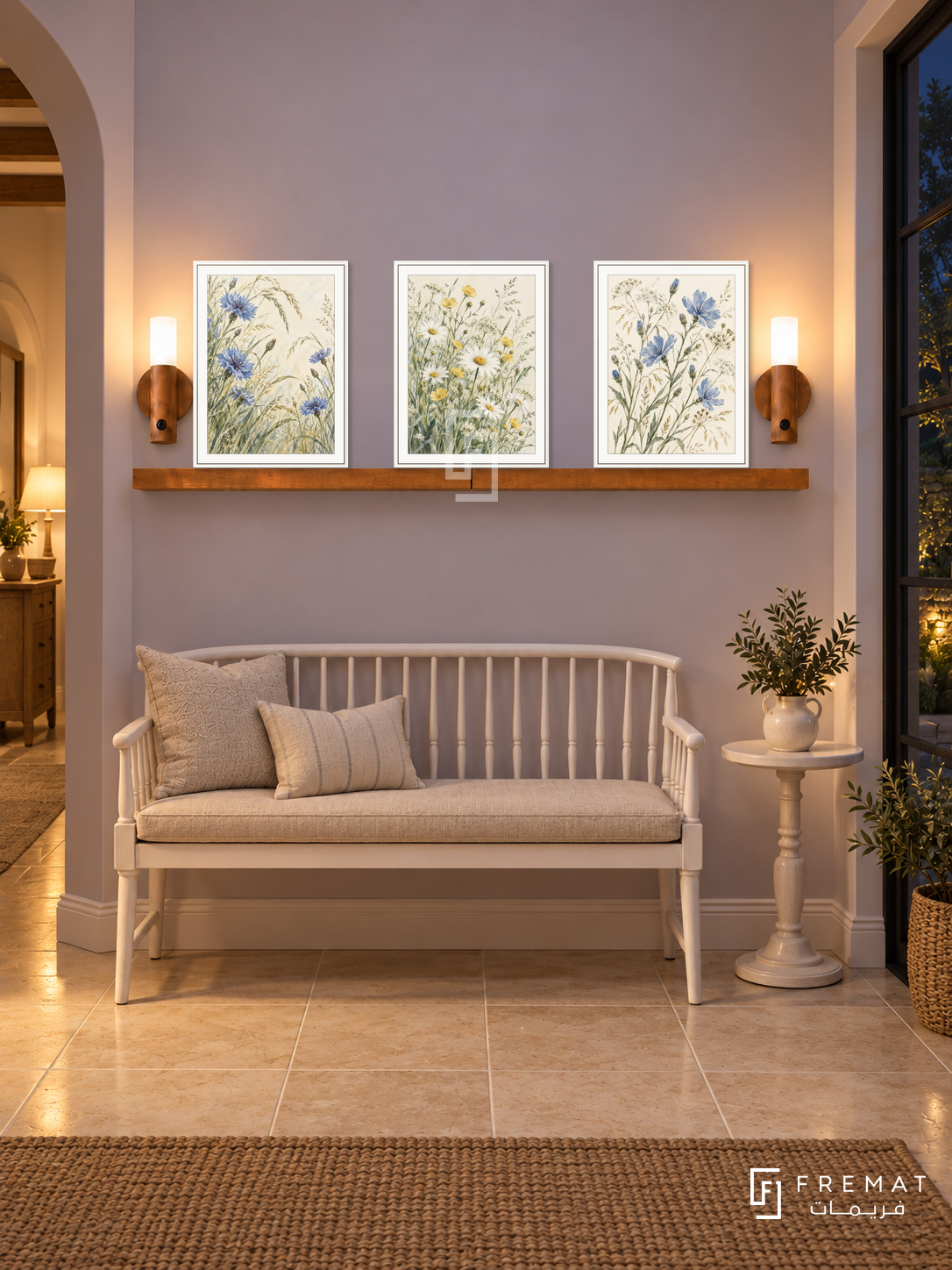 FREMAT Wildflower Meadow shelf set with three 30 x 40 cm white frames, 2 cm white borders, honey wood shelf and two warm sensor lamps. Night cottage-inspired corridor, pale lavender wall, white spindle bench with linen cushion, small round painted table, cream tiled floor, dark garden window right.