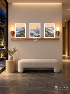 FREMAT Mountain Light shelf set with three 30 x 40 cm white frames, 2 cm white borders, honey wood shelf and two warm sensor lamps. Night alpine modern corridor, ivory plaster, white wool bench, birch cylinder table, grey slate floor, dark pine courtyard left, clean ceiling wash.
