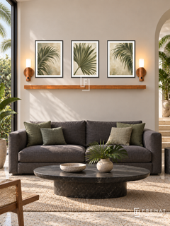 FREMAT Palm Reverie shelf set with three 30 x 40 cm black frames, 2 cm white borders, honey wood shelf and two warm sensor lamps. Morning tropical modern living room, pale sand wall, charcoal linen sofa with green cushions, black stone oval table, terrazzo, palm garden window left, white arch right.