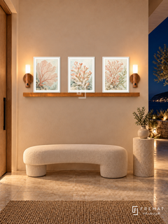 FREMAT Coral Garden shelf set with three 30 x 40 cm white frames, 2 cm white borders, honey wood shelf and two warm sensor lamps. Night contemporary seaside entrance, soft peach plaster, ivory curved bench, pale limestone pedestal, stone floor, dark terrace right and oak door left.