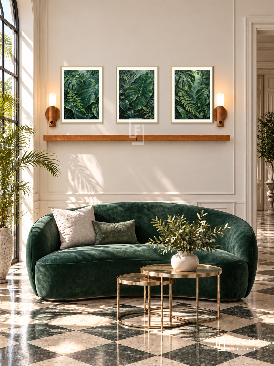 FREMAT Rainforest Layers shelf set with three 30 x 40 cm gold frames, 2 cm white borders, honey wood shelf and two warm sensor lamps. Morning glamorous botanical reception, cream wall, emerald curved loveseat, brass nesting tables, chequered stone floor, tall window left with palms, moulded doorway right.