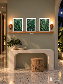 FREMAT Rainforest Layers shelf set with three 30 x 40 cm white frames, 2 cm white borders, honey wood shelf and two warm sensor lamps. Night tropical contemporary corridor, pale sage wall, sculptural white console, cane stool, terrazzo floor, moonlit foliage through arch right, narrow passage left.