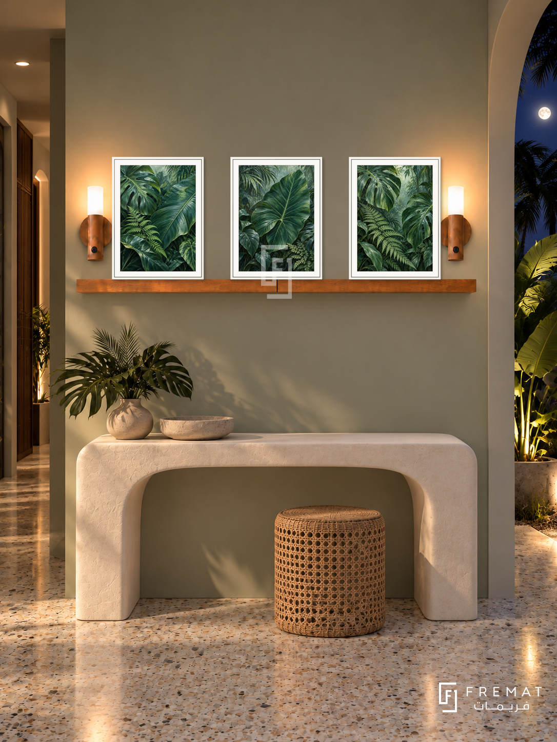 FREMAT Rainforest Layers shelf set with three 30 x 40 cm white frames, 2 cm white borders, honey wood shelf and two warm sensor lamps. Night tropical contemporary corridor, pale sage wall, sculptural white console, cane stool, terrazzo floor, moonlit foliage through arch right, narrow passage left.