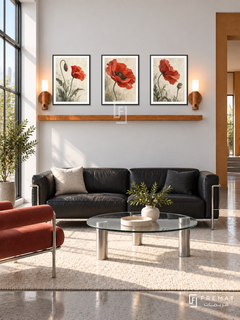 FREMAT Poppy Movement shelf set with three 30 x 40 cm black frames, 2 cm white borders, honey wood shelf and two warm sensor lamps. Morning Bauhaus living room, chalk white wall, red tubular lounge chair beside black leather sofa, circular glass table, polished concrete floor, steel window left, ochre doorway right.