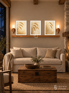 FREMAT Wheat And Wind shelf set with three 30 x 40 cm wooden texture frames, 2 cm white borders, honey wood shelf and two warm sensor lamps. Night rustic farmhouse lounge, sand wall, oak settle with cream linen cushions, low timber chest table, woven rug, dark countryside window left, heavy beams and stone hearth right.