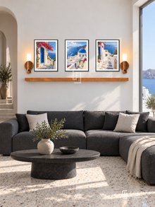 FREMAT Aegean Light shelf set with three 30 x 40 cm black frames, 2 cm white borders, honey wood shelf and two warm sensor lamps. Morning Cycladic modern lounge, chalk white wall, charcoal linen sectional, oval black stone table, pale terrazzo, Aegean sea window right, rounded passage left.