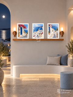 FREMAT Aegean Light shelf set with three 30 x 40 cm white frames, 2 cm white borders, honey wood shelf and two warm sensor lamps. Night Greek island foyer, ivory limewash, built-in white curved bench, pale blue stool, limestone floor, moonlit sea through arch left, recessed warm lights.