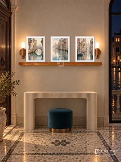 FREMAT Venetian Reflections shelf set with three 30 x 40 cm white frames, 2 cm white borders, honey wood shelf and two warm sensor lamps. Night Venetian foyer, pearl plaster, ivory fluted console, teal stool, mosaic stone floor, dark canal through window right, antique door left.