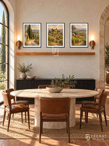 FREMAT Tuscan Afternoon shelf set with three 30 x 40 cm black frames, 2 cm white borders, honey wood shelf and two warm sensor lamps. Morning Tuscan modern dining room, warm cream plaster, black sideboard below shelf, oval travertine table with leather chairs, terracotta floor, cypress window left, stone arch right.