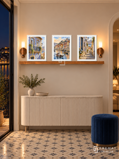 FREMAT Porto Tiles shelf set with three 30 x 40 cm white frames, 2 cm white borders, honey wood shelf and two warm sensor lamps. Night Portuguese foyer, ivory wall, white fluted console, blue velvet stool, small patterned floor tiles, dark river balcony left, warm recessed lighting.