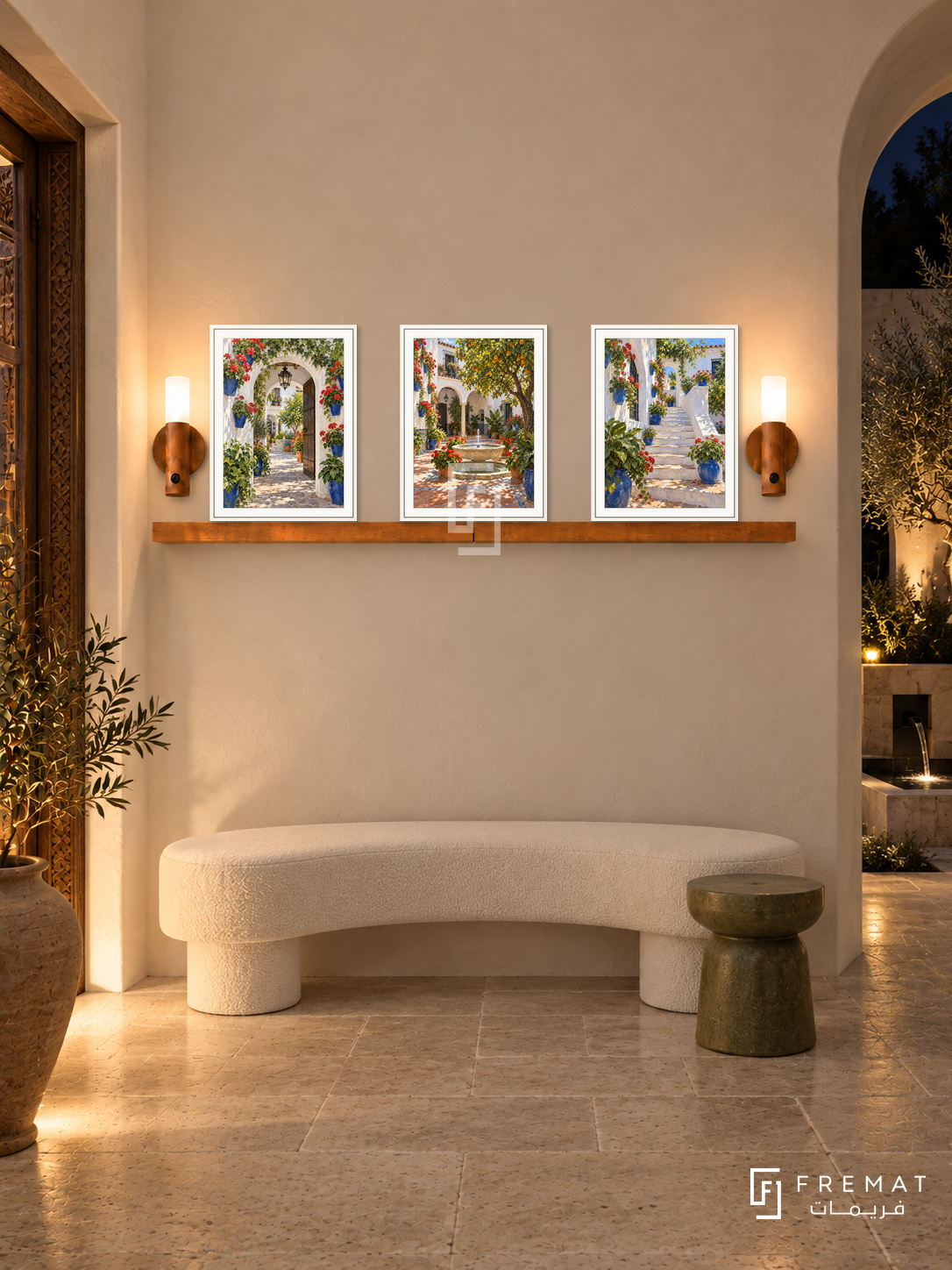 FREMAT Andalusian Patios shelf set with three 30 x 40 cm white frames, 2 cm white borders, honey wood shelf and two warm sensor lamps. Night Spanish courtyard foyer, ivory plaster, curved white bench, olive stool, limestone floor, dark fountain courtyard right, carved doorway left.
