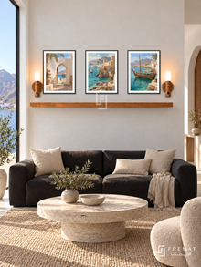 FREMAT Oman Earth And Sea shelf set with three 30 x 40 cm black frames, 2 cm white borders, honey wood shelf and two warm sensor lamps. Morning Muscat coastal modern sitting room, white lime plaster, black low sofa with sand cushions, pale travertine round table, mountain coast side glazing.