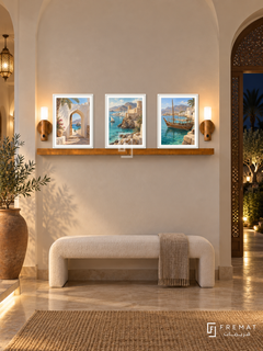 FREMAT Oman Earth And Sea shelf set with three 30 x 40 cm white frames, 2 cm white borders, honey wood shelf and two warm sensor lamps. Night Omani villa foyer, ivory arched entry, white upholstered bench, tall terracotta vessel, dark garden through carved side doorway.
