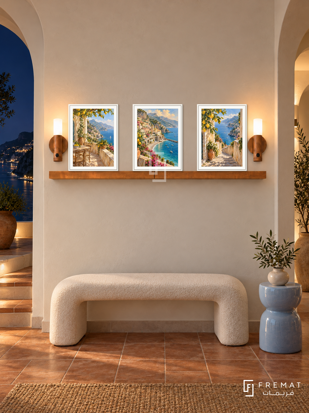 FREMAT Amalfi Terraces shelf set with three 30 x 40 cm white frames, 2 cm white borders, honey wood shelf and two warm sensor lamps. Night Amalfi foyer, white sculptural bench, pale sky blue ceramic side stool, cream arched architecture, dark coastal lights and terracotta floor.