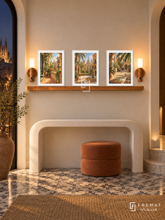 FREMAT Barcelona Sun shelf set with three 30 x 40 cm white frames, 2 cm white borders, honey wood shelf and two warm sensor lamps. Night Barcelona sculptural entry, warm ivory wall, white curved console, terracotta ottoman, patterned tile floor and city lights at side.