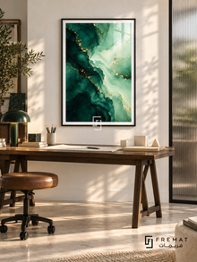 Emerald Tide: Deep emerald ink-like pools flow into pale mint layers, traced with gold-colored veins and scattered dots. Black PVC frame displayed with a dark trestle desk and leather stool.