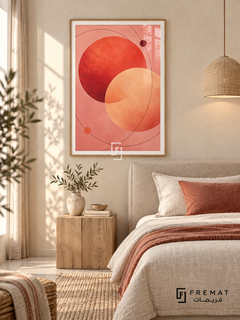 Coral Orbit: Overlapping coral-red and apricot circles float on blush pink, crossed by fine burgundy orbital curves and two small dots. Wooden Texture PVC frame displayed with a linen bed with rust textiles.