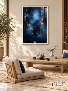 Midnight Vein: Luminous blue clouds emerge from deep navy and near-black textures, crossed by fine sweeping gold-colored veins and flecks. Wooden Texture PVC frame displayed with a low oak tea table and upholstered floor chairs.