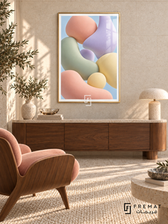 Pastel Drift: Softly shaded pebble-like forms in peach, sage, lilac and pale yellow float together against a light blue background. Gold PVC frame displayed with a stone-topped walnut sideboard and peach lounge chair.