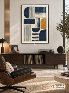 Indigo Cadence: Indigo semicircles, rectangles and parallel stripes form a rhythmic arrangement on textured cream, accented by a single ochre rounded block. Black PVC frame displayed with a walnut record cabinet and black leather lounge chair.