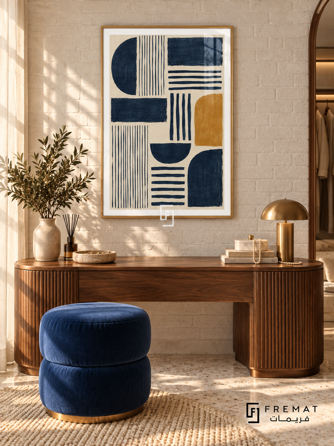 Indigo Cadence: Indigo semicircles, rectangles and parallel stripes form a rhythmic arrangement on textured cream, accented by a single ochre rounded block. Gold PVC frame displayed with a rounded walnut vanity and navy upholstered stool.