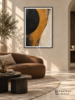 Ochre Eclipse: A large cropped black disc meets a sweeping ochre band and an ivory field, with weathered painterly textures and dark scuffed edges. Black PVC frame displayed with a curved brown leather sofa and dark nesting tables.