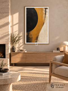 Ochre Eclipse: A large cropped black disc meets a sweeping ochre band and an ivory field, with weathered painterly textures and dark scuffed edges. Wooden Texture PVC frame displayed with a pale oak sideboard beside a stone fireplace.
