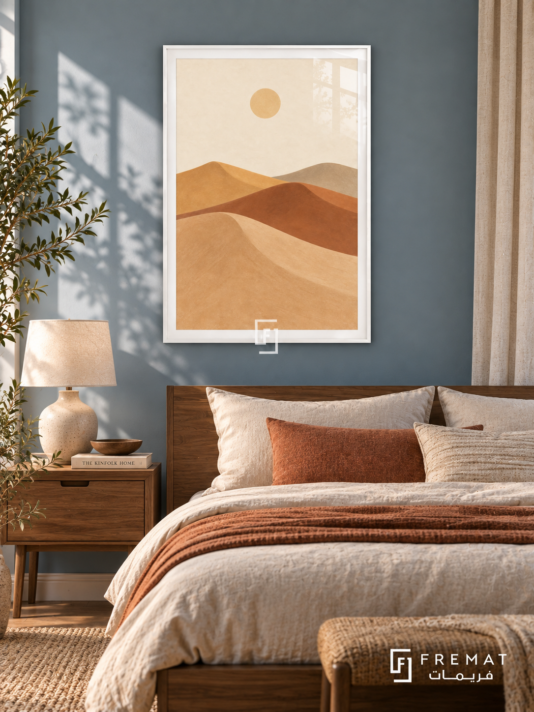 Desert Dunes. Sweeping layers of sand, clay, ochre and taupe dunes sit beneath a small pale sun. Shown in a White PVC frame in a styled room.
