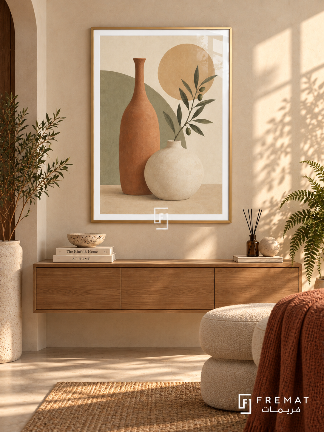 Sculptural Vessels. A tall terracotta vase and rounded ivory vessel meet an olive branch, sage block and ochre disk. Shown in a Gold PVC frame in a styled room.