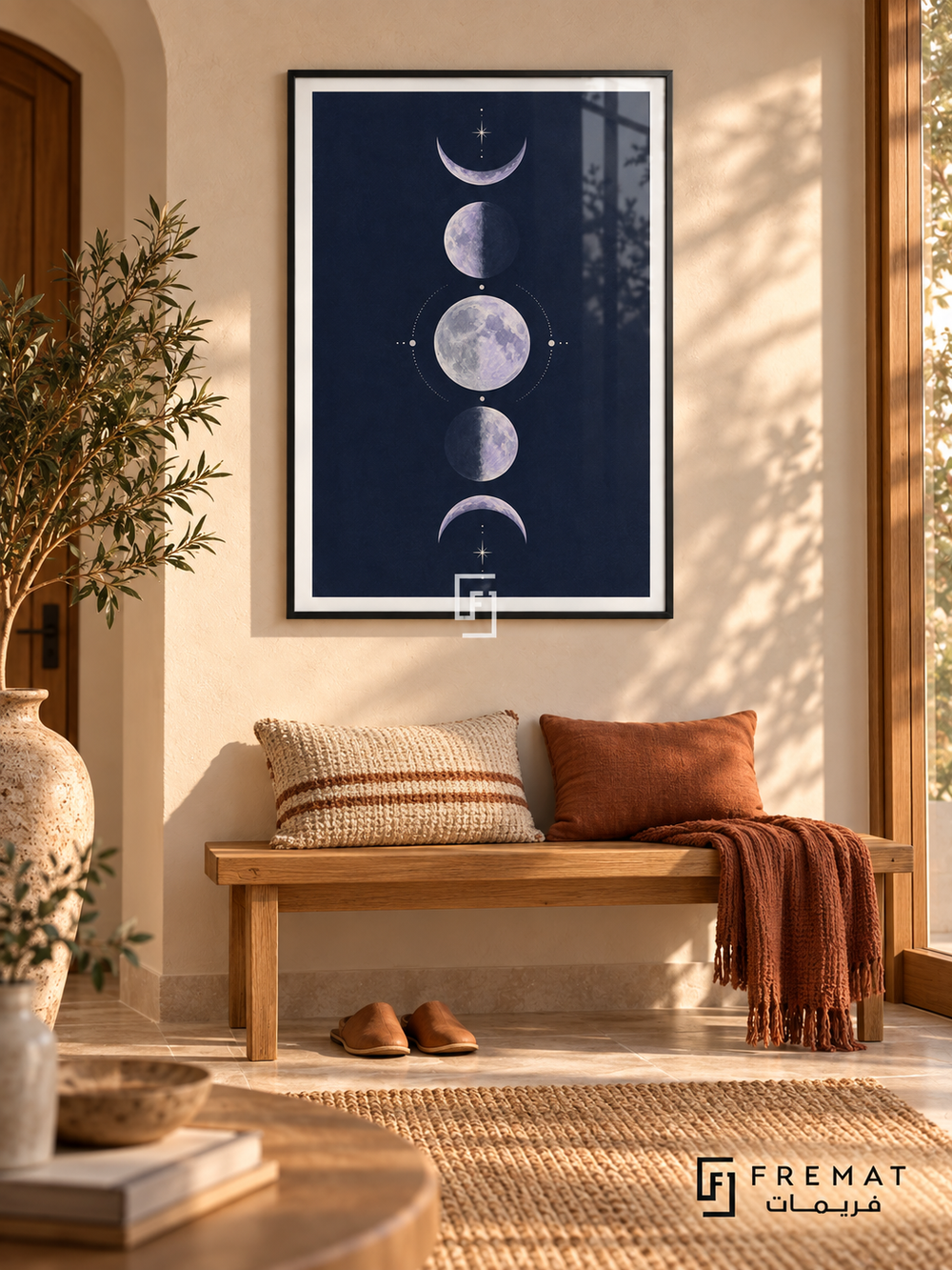 Indigo Moons. Five lavender moon phases form a vertical column among delicate cream stars on a navy background. Shown in a Black PVC frame in a styled room.