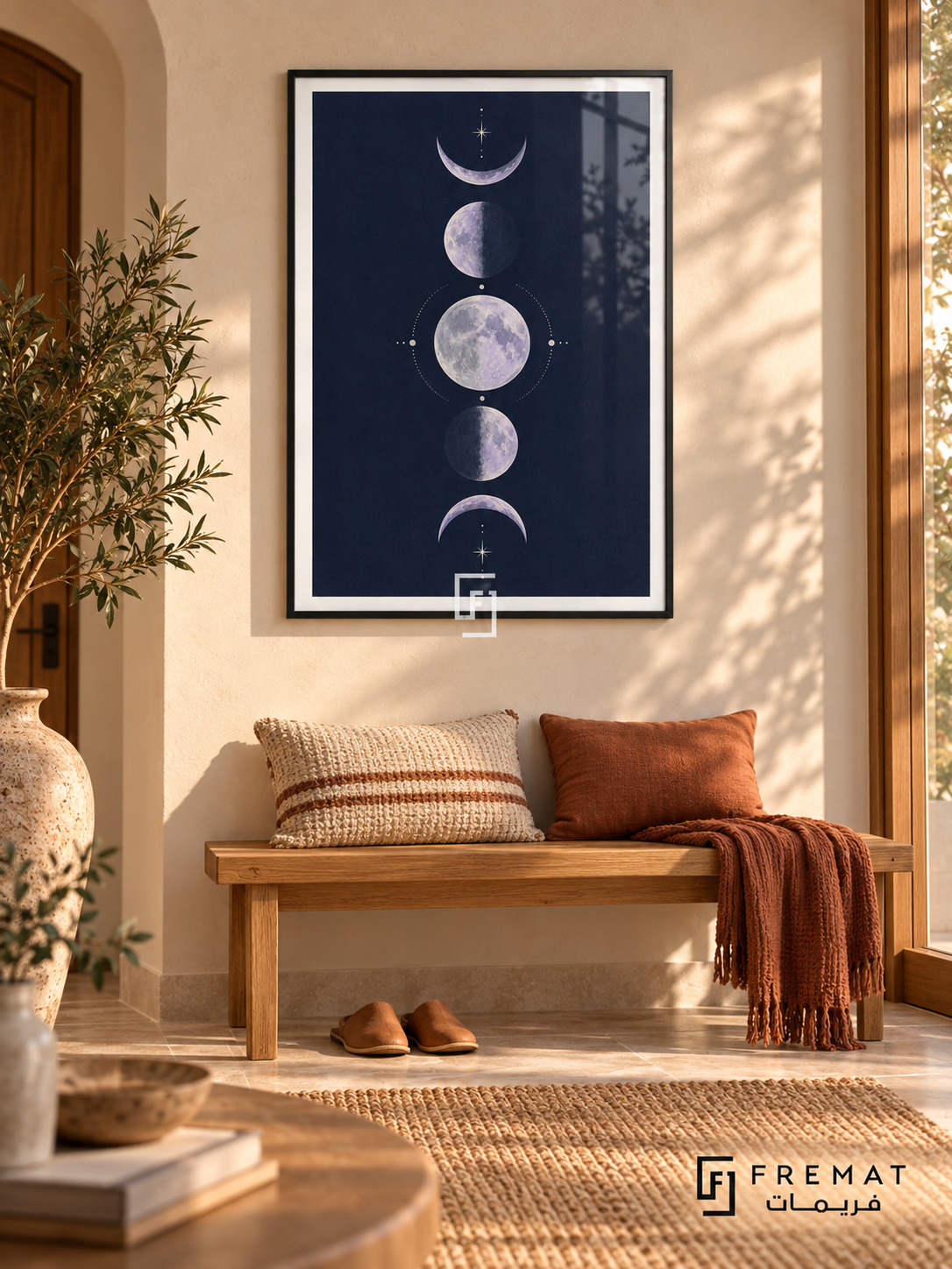 Indigo Moons. Five lavender moon phases form a vertical column among delicate cream stars on a navy background. Shown in a Black PVC frame in a styled room.