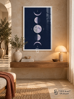 Indigo Moons. Five lavender moon phases form a vertical column among delicate cream stars on a navy background. Shown in a White PVC frame in a styled room.