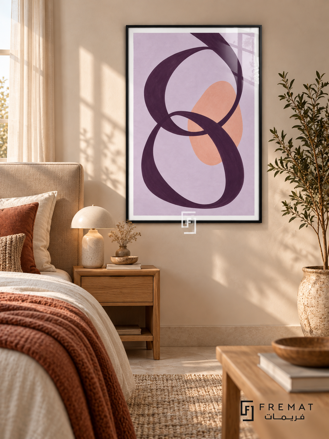 Lilac Loops. A looping plum ribbon crosses a peach oval on a lavender background. Shown in a Black PVC frame in a styled room.