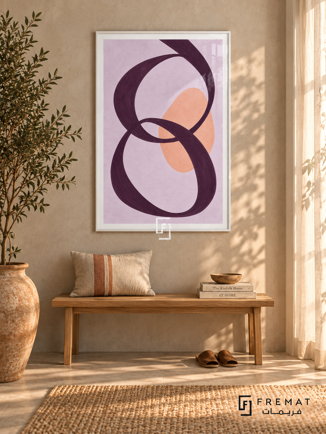 Lilac Loops. A looping plum ribbon crosses a peach oval on a lavender background. Shown in a White PVC frame in a styled room.