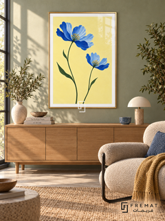 Blue Wildflowers. Two blue flowers on green stems brighten a buttery yellow background. Shown in a Gold PVC frame in a styled room.