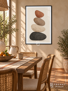 Balanced Stones. Four charcoal, ivory, taupe and terracotta stones form a quiet vertical stack. Shown in a Black PVC frame in a styled room.