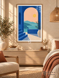 Blue Arch View. A cobalt arch and steps frame turquoise water, distant hills and a yellow sun, with a potted leafy branch. Shown in a Wooden Texture PVC frame in a styled room.