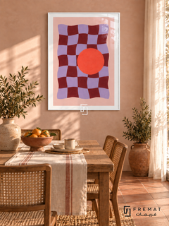 Playful Checker. A wavy burgundy and lavender checkerboard meets a bold coral-orange circle on pink. Shown in a White PVC frame in a styled room.