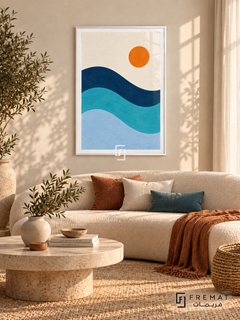 Blue Tide. Three flowing navy, turquoise and pale blue wave bands sit below an orange sun in an ivory sky. Shown in a White PVC frame in a styled room.