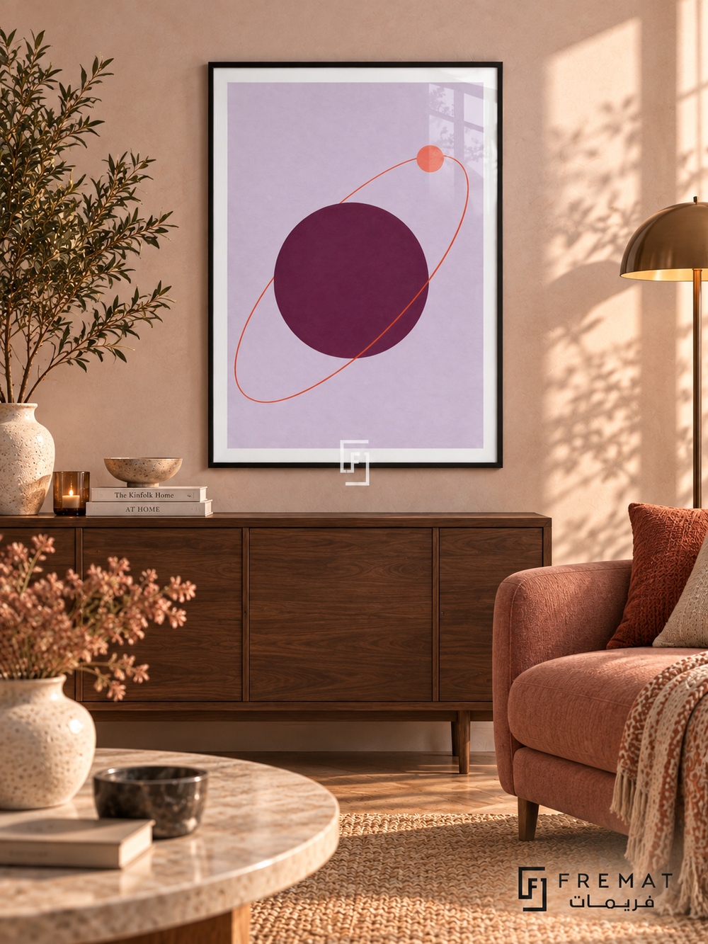 Plum Orbit. A coral orbit and small disk circle a large plum sphere on lavender. Shown in a Black PVC frame in a styled room.