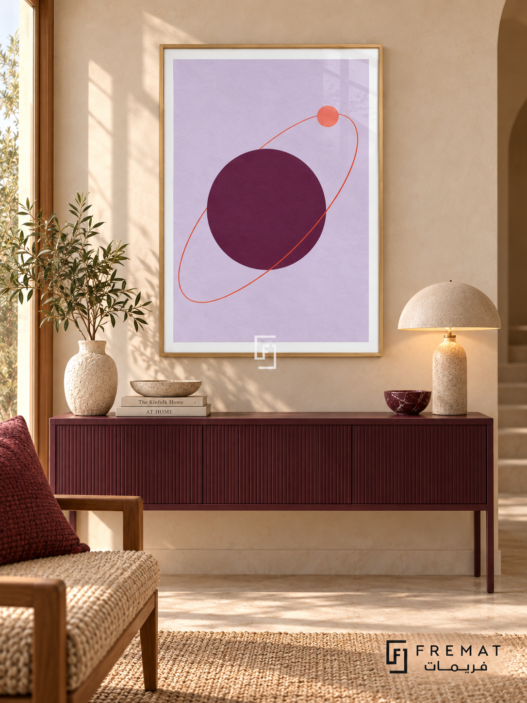Plum Orbit. A coral orbit and small disk circle a large plum sphere on lavender. Shown in a Wooden Texture PVC frame in a styled room.