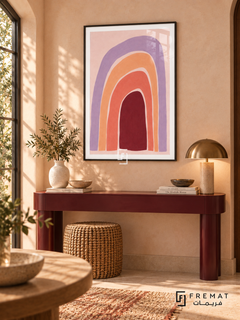 Pastel Rhythm. Uneven nested arches in lavender, peach, coral and burgundy create a warm rainbow-like rhythm on pink. Shown in a Black PVC frame in a styled room.