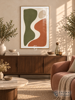 Cut Paper Dialogue. Olive-green and terracotta organic shapes face one another across an ivory curve beneath a sand-colored oval. Shown in a Gold PVC frame in a styled room.