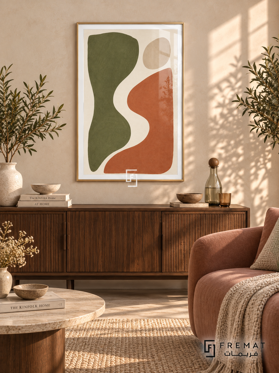 Cut Paper Dialogue. Olive-green and terracotta organic shapes face one another across an ivory curve beneath a sand-colored oval. Shown in a Gold PVC frame in a styled room.