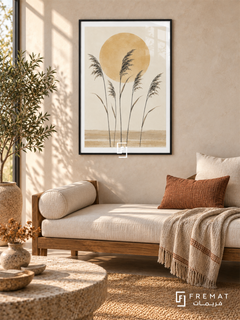 Sun and Reeds. Five delicate dark reed stems stand before an ochre sun above sandy horizontal bands. Shown in a Black PVC frame in a styled room.