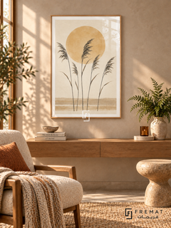 Sun and Reeds. Five delicate dark reed stems stand before an ochre sun above sandy horizontal bands. Shown in a Wooden Texture PVC frame in a styled room.