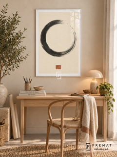 Ink Stillness. A charcoal dry-brush circle and small terracotta square create a spare composition on warm ivory. Shown in a White PVC frame in a styled room.