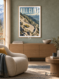 Hill Climb (car09), Wooden Texture frame with white printed border in a styled interior. A yellow sports car rounds a pale winding mountain road above a blue lake, rocky slopes and evergreen trees. Tall cream lettering reads HILL CLIMB.