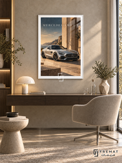 Mercedes-AMG GT Coastal (car13), White frame with white printed border in a styled interior. A silver Mercedes-AMG GT stands beside sunlit stone architecture overlooking a rocky coast. Warm beige stone and muted blue sky surround the car beneath MERCEDES-AMG GT lettering.